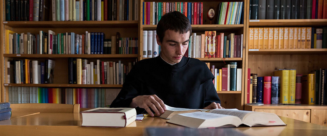 Murezi studies scripture Murezi Casanova sits at a desk reading scripture