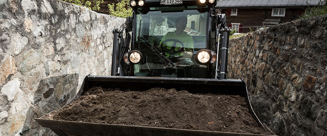Transporting soil using a Bobcat Murezi uses a Bobcat to transport soil