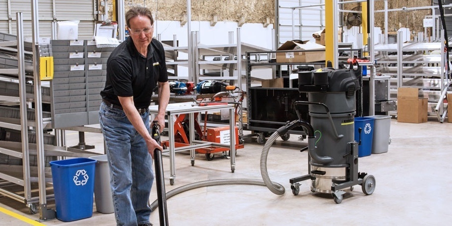 Single-Phase Industrial Vacuums worker uses a single-phase industrial vacuum in a shop
