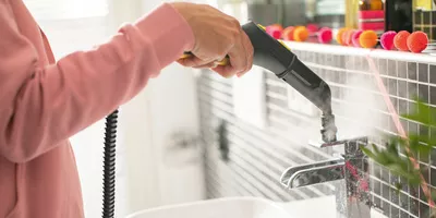 Cleaning of water tap with with steam cleaner brush
