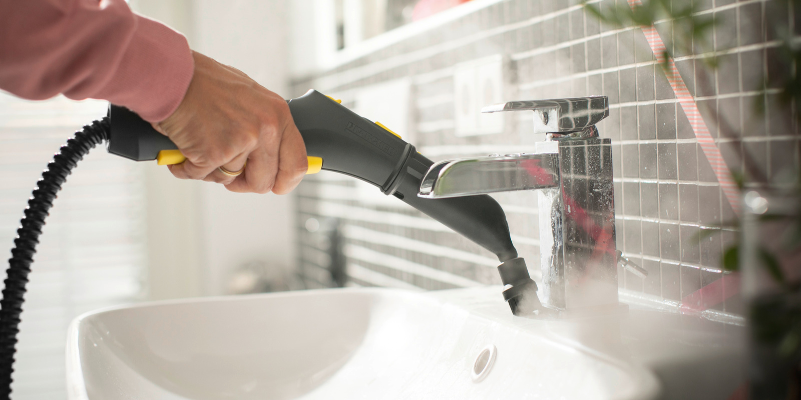 Bathroom cleaning with steam cleaner Person cleaning bathroom using Kärcher steam cleaner