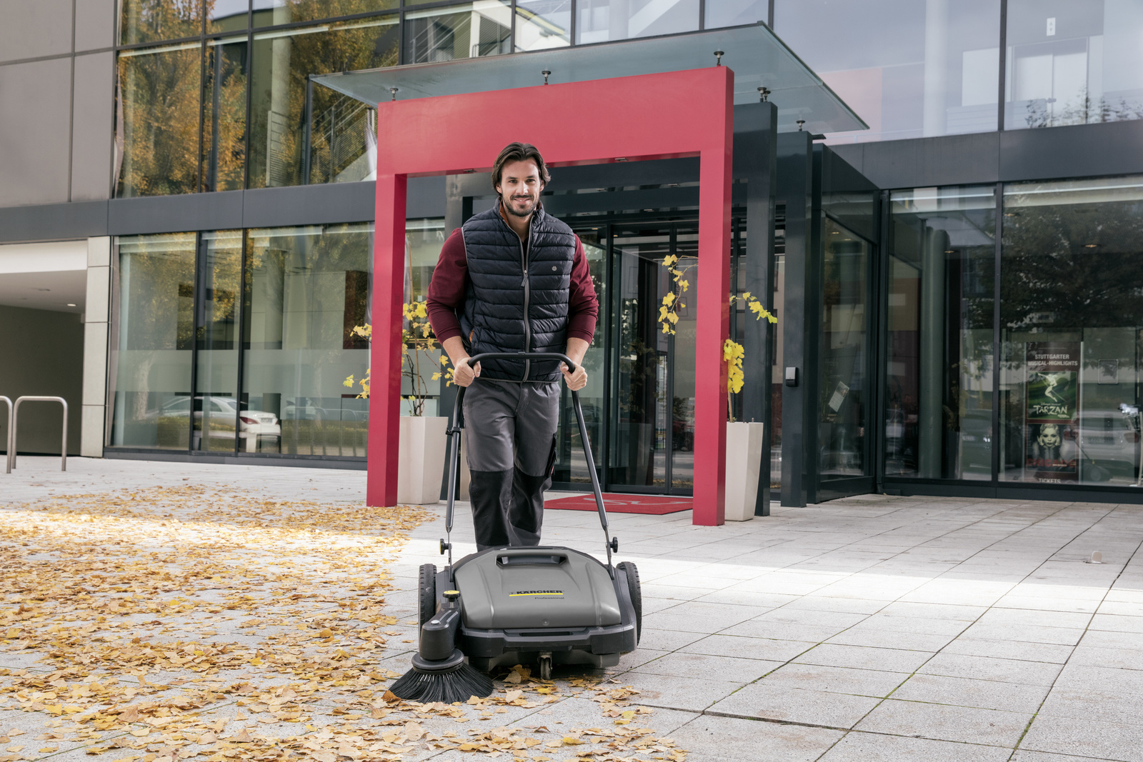 Ride-on vacuum sweeper in use Man seen cleaning a warehouse using a Kärcher ride-on vacuum sweeper
