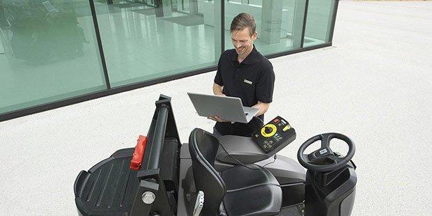 Professional Services Kärcher service technician examines equipment