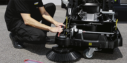Service Centers A Kärcher technician services a walk-behind floor sweeper