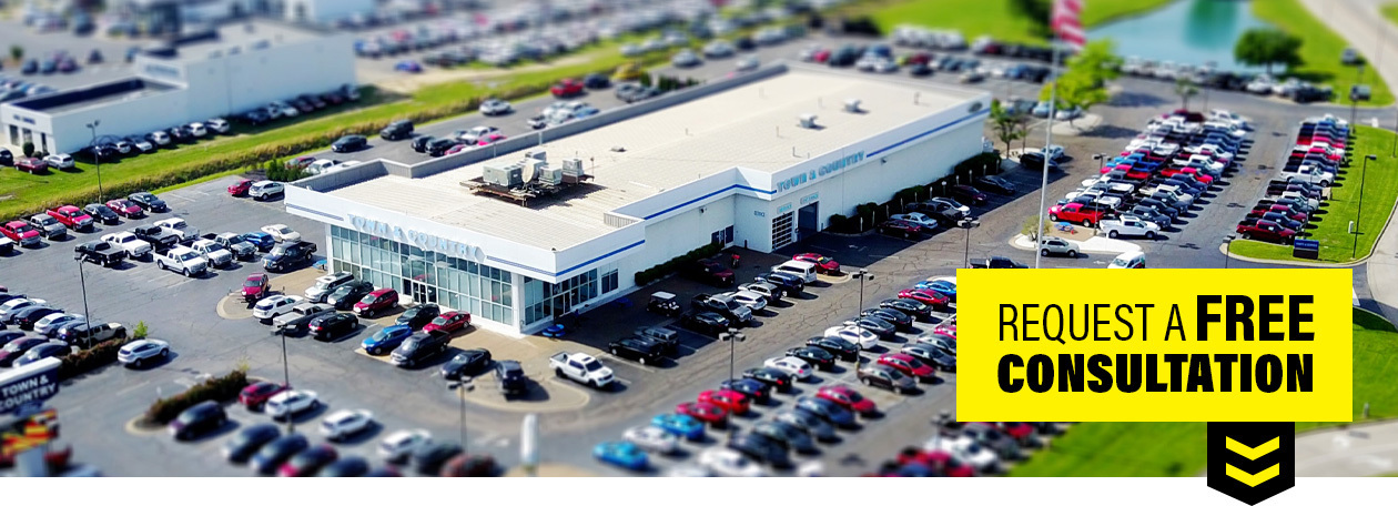 cleaning solutions for the automotive industry aerial view of a car dealership with dozens of cars on the lot