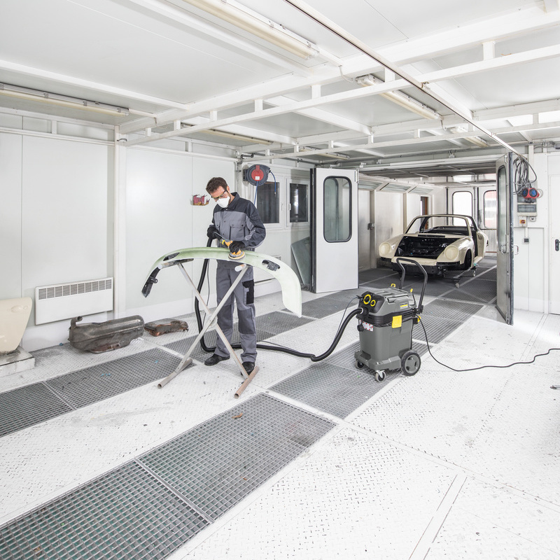 Person uses Kärcher safety vacuum cleaner in paint shop Person uses Kärcher safety vacuum cleaner in paint shop