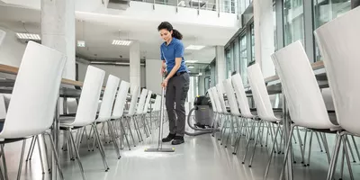 Person cleaning a canteen floor