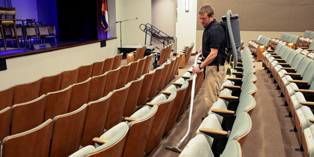 Kärcher Commercial Backpack Vacuums A worker uses a Kärcher BV 11/1 HEPA commercial backpack vacuum inside a theater.