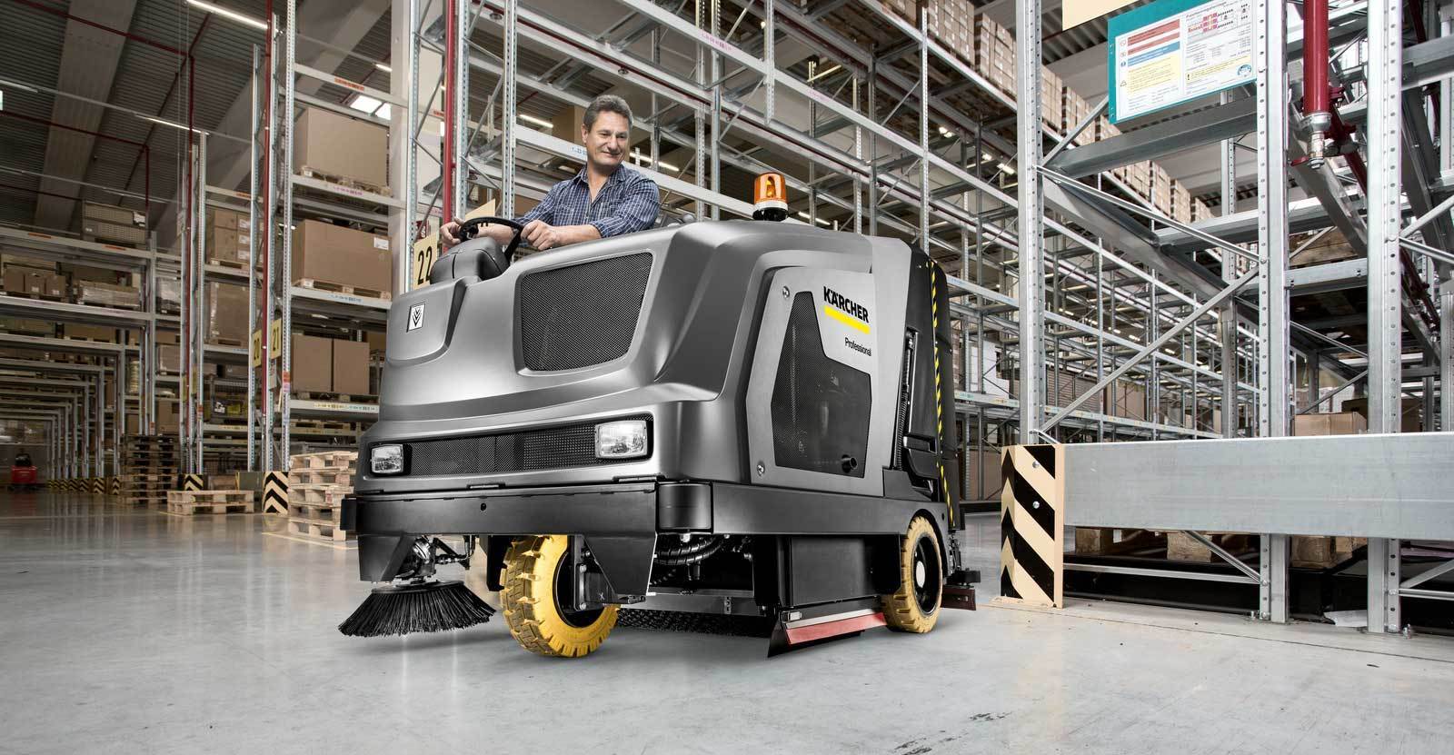 Kärcher B 300 ride-on scrubber Man cleaning warehouse with Kärcher B 300 ride-on scrubber
