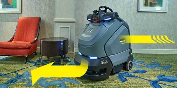 KIRA provides increased productivity Kärcher KIRA commercial robotic vacuum maneuvering around chair